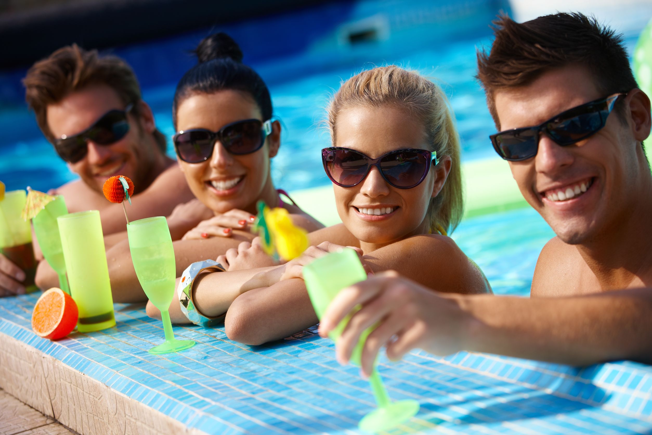 4 adults in pool with drinks