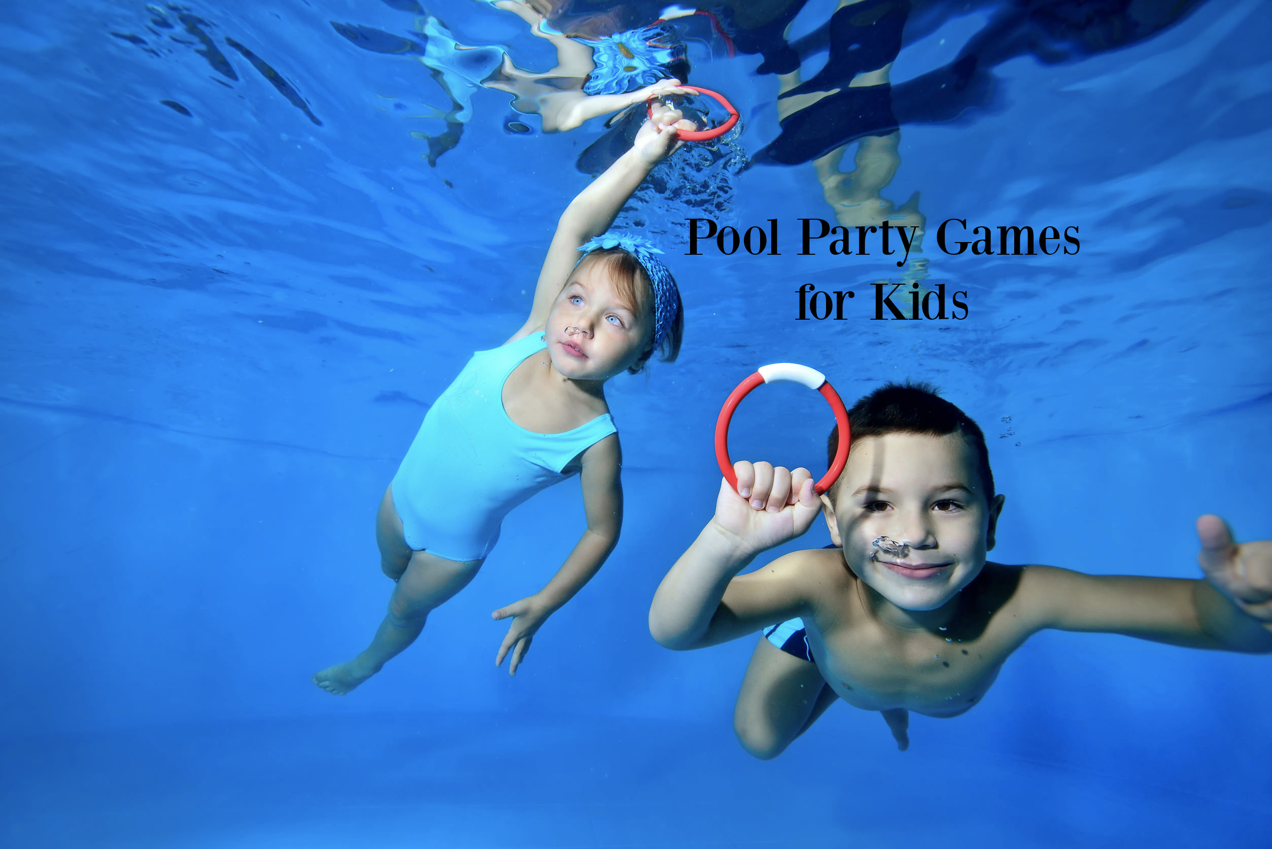 girl and boy with dive rings underwater