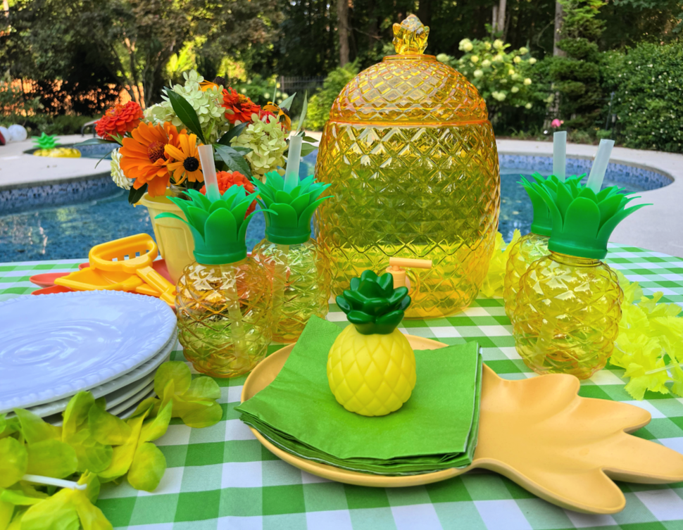 pool party table with pineapple water dispenser and cups