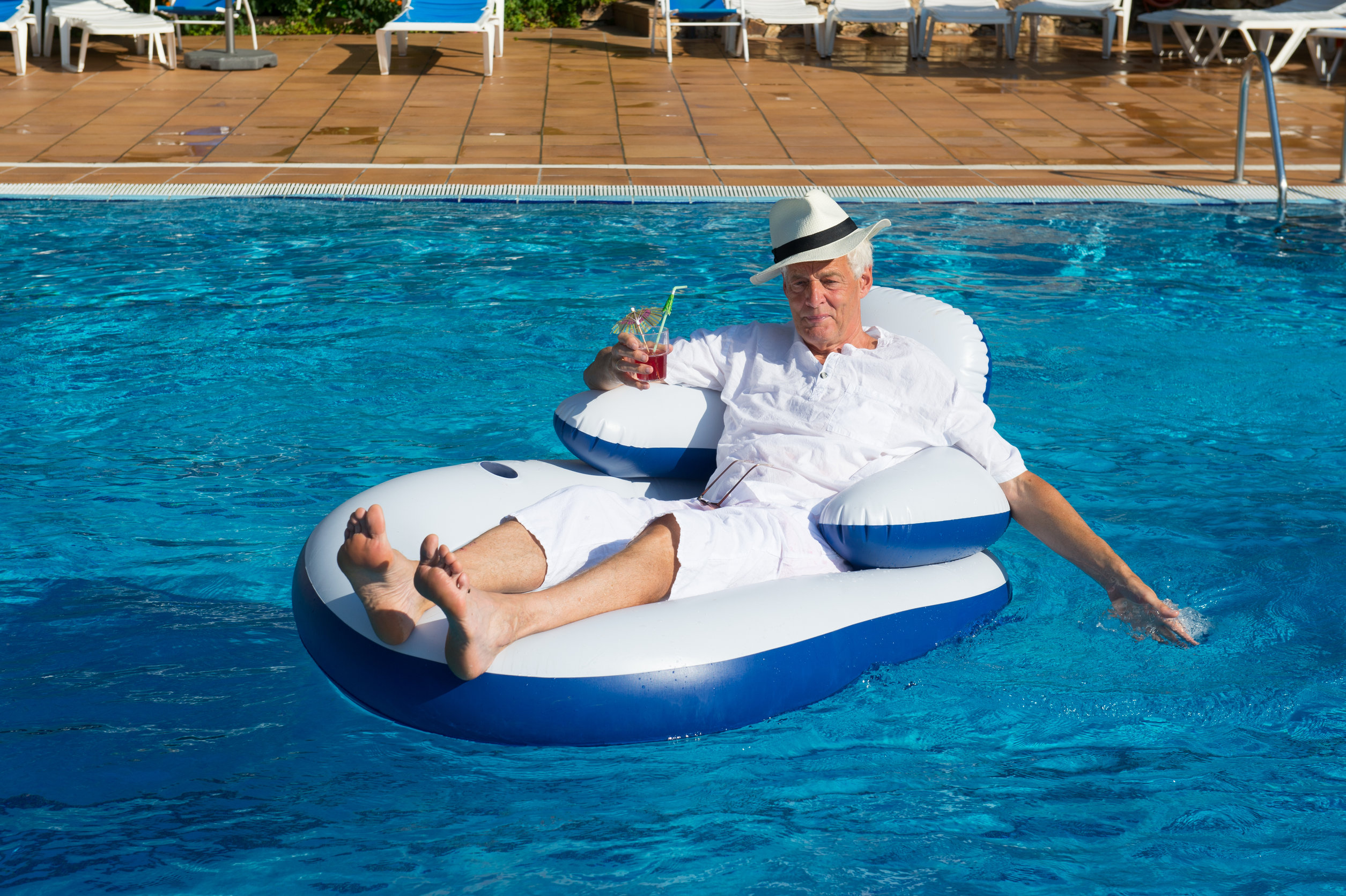 man in pool lounge float