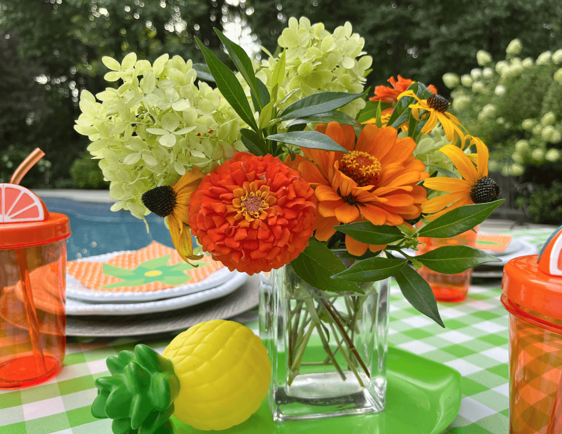 orange zinnia bouquet for pool party table centerpiece