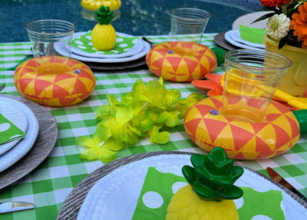 3 pineapple shaped cup coasters on a Hawaiian pool party table
