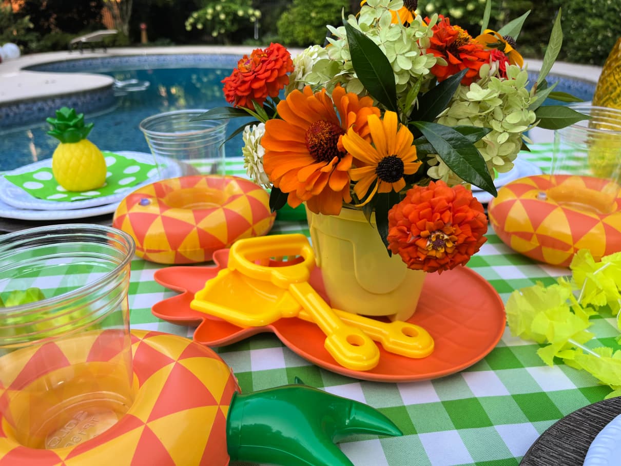 Hawaiian pool party table using lime green, yellow and orange decor