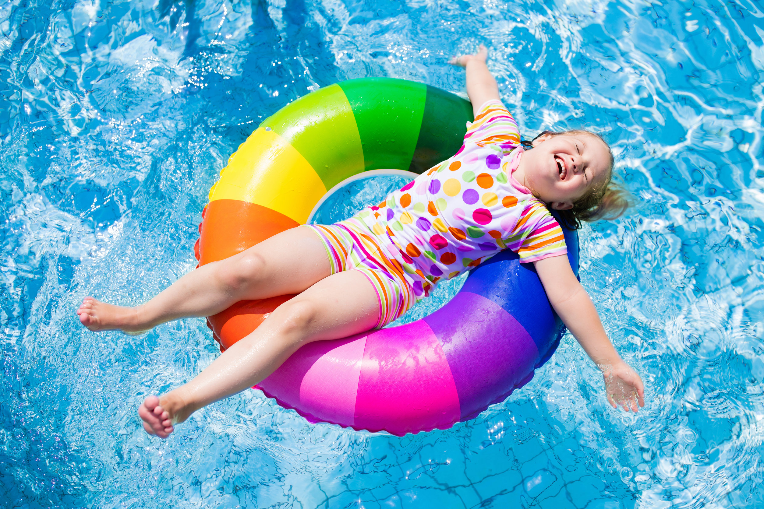 young girl in colorful swim ring