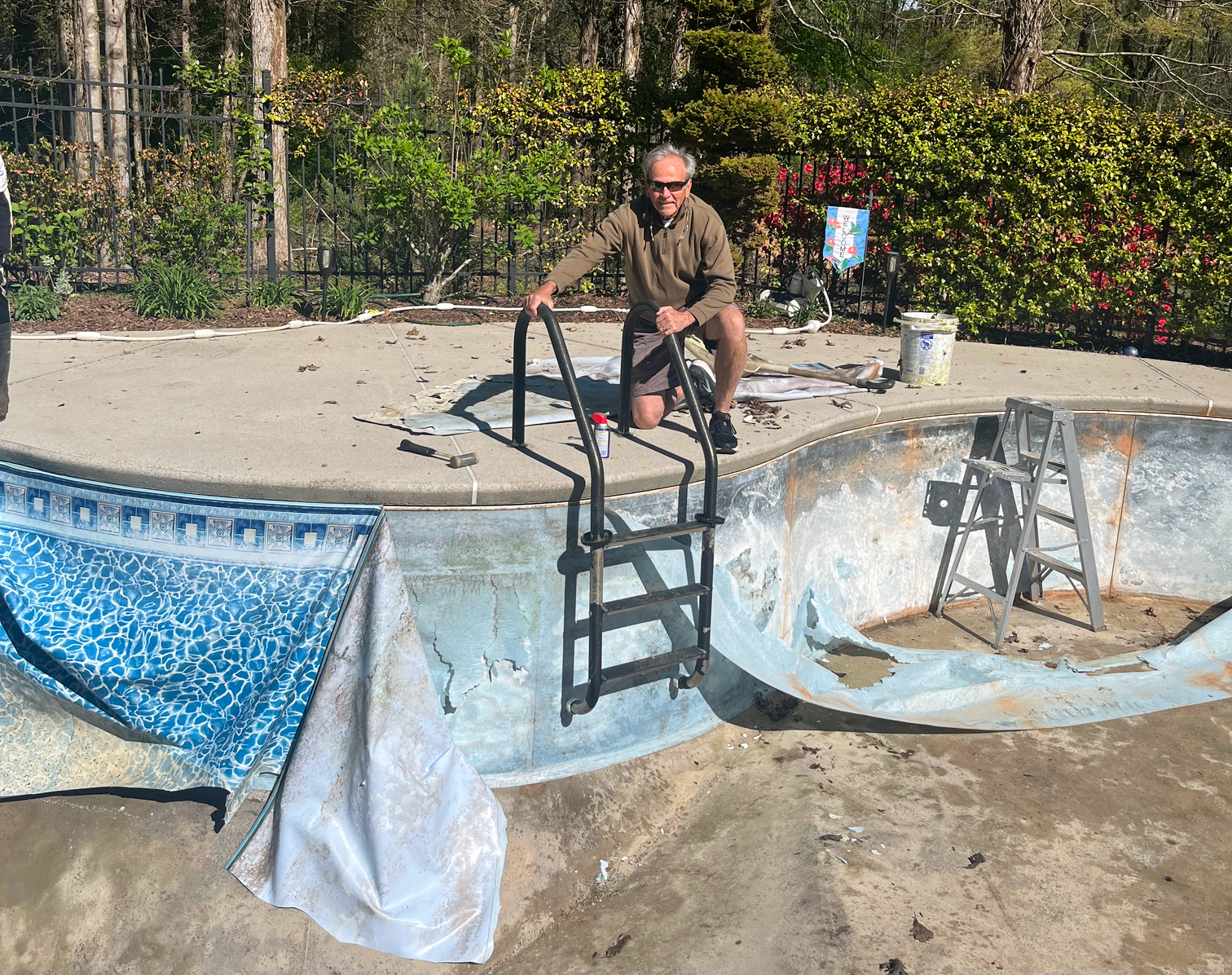 faded inground pool liner being removed