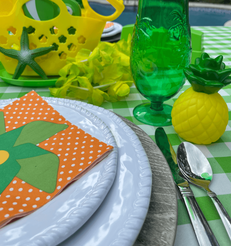 white pool party table plates with colorful napkins and cups